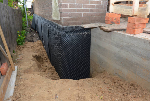 Happy homeowners after waterproofing job in West Grove